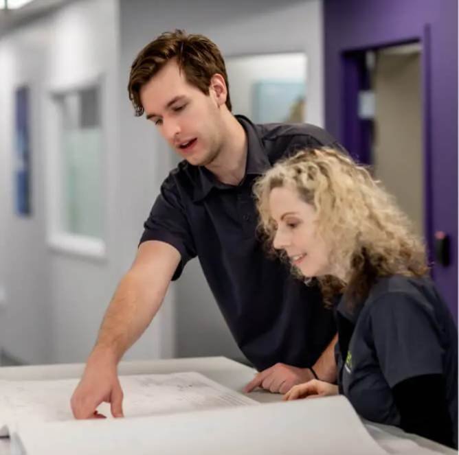 Two people reviewing documents.