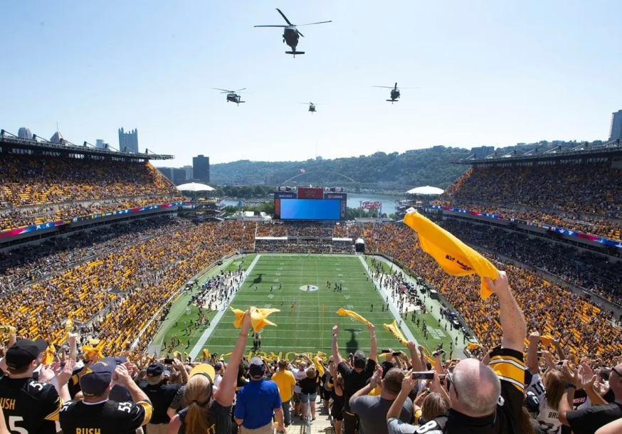 Helicopters flying over a Steelers game.